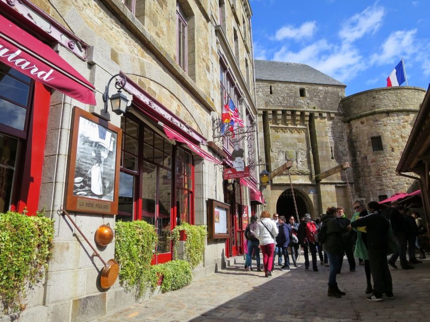 From Paris: Small-Group Mont St Michel Tour & Cider Tasting - Entering Mont St-Michel and climbing toward the abbey