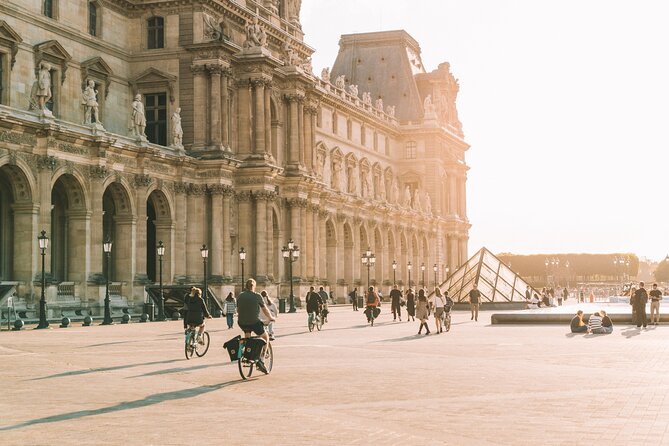 Paris Evening City of Lights Small Group Bike Tour & Boat Cruise - Riding past the Louvre and Musée d’Orsay
