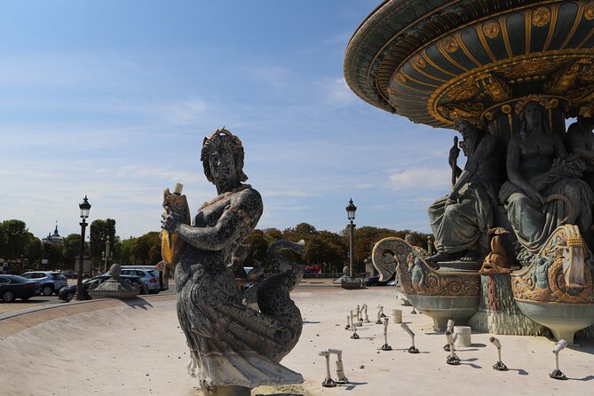 Paris Revolutionary Walking Tour: Iconic French Sights & Stories - Place Vendôme and modern Parisian luxury