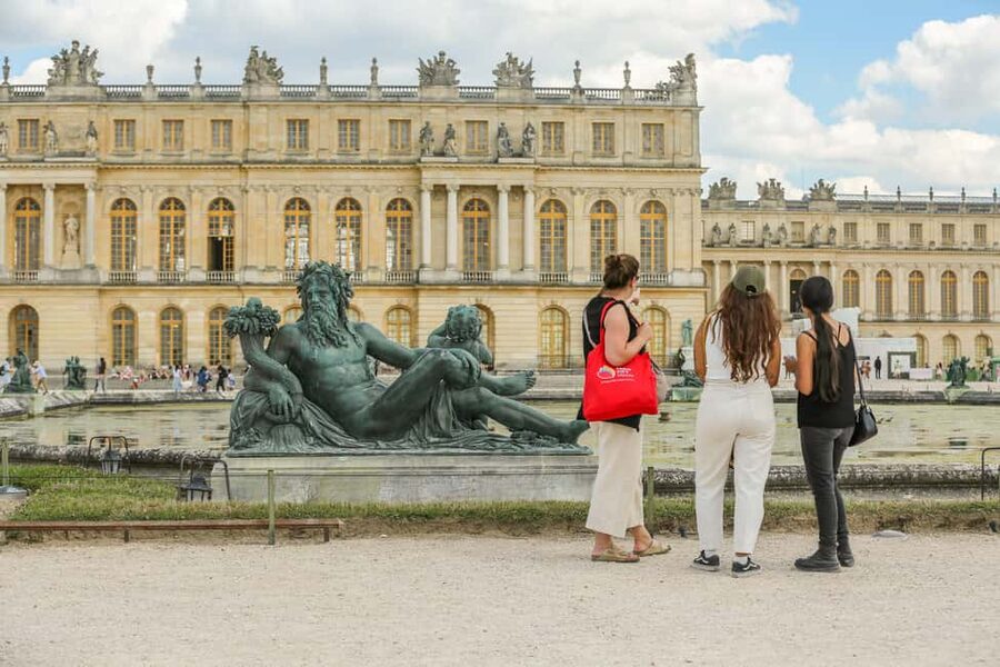 Versailles: Skip-the-Line Day Tour & Transfer from Paris - Walking through the gardens toward the Grand Canal